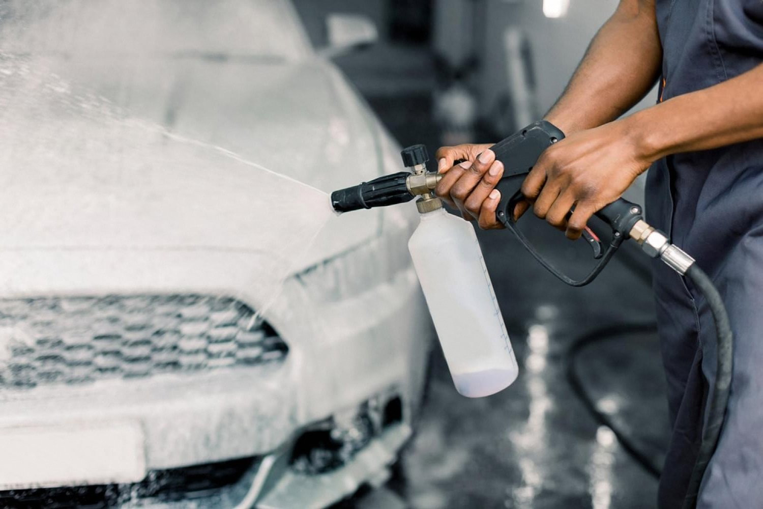 Foam cannon washing a car before paint protection treatment