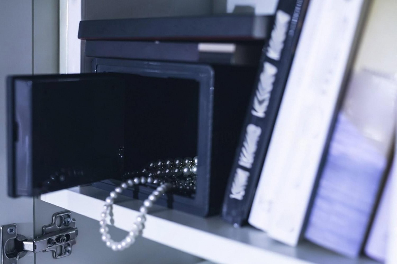 Compact luxury safe on a shelf in a Dubai home storing pearl jewellery