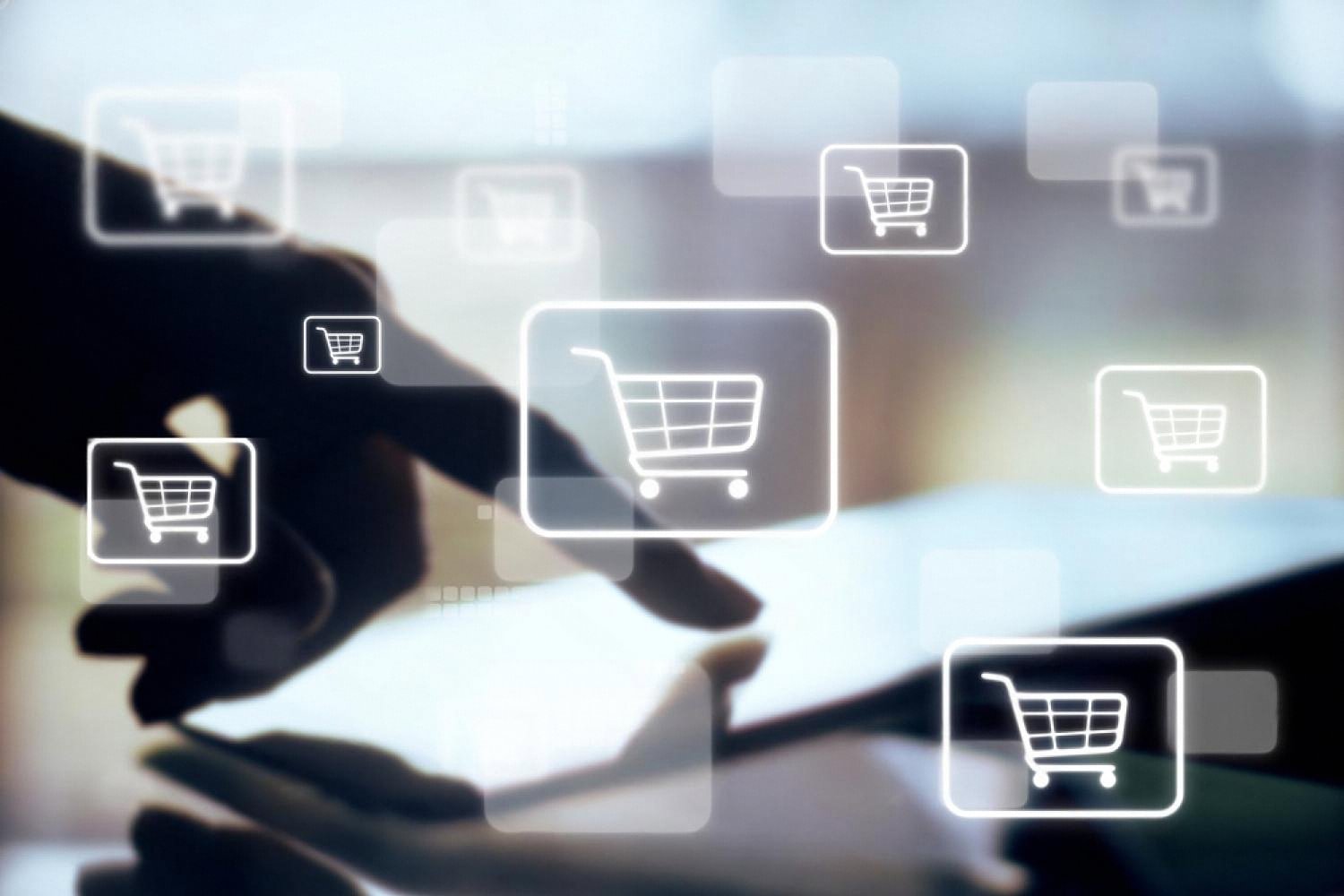 Hand tapping shopping cart icons floating above a tablet, representing listing clicks